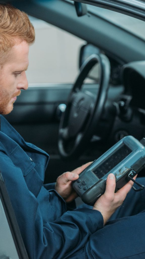 Mechanic looking at his diagnostics tools - Vehicle Diagnostics Kilmarnock